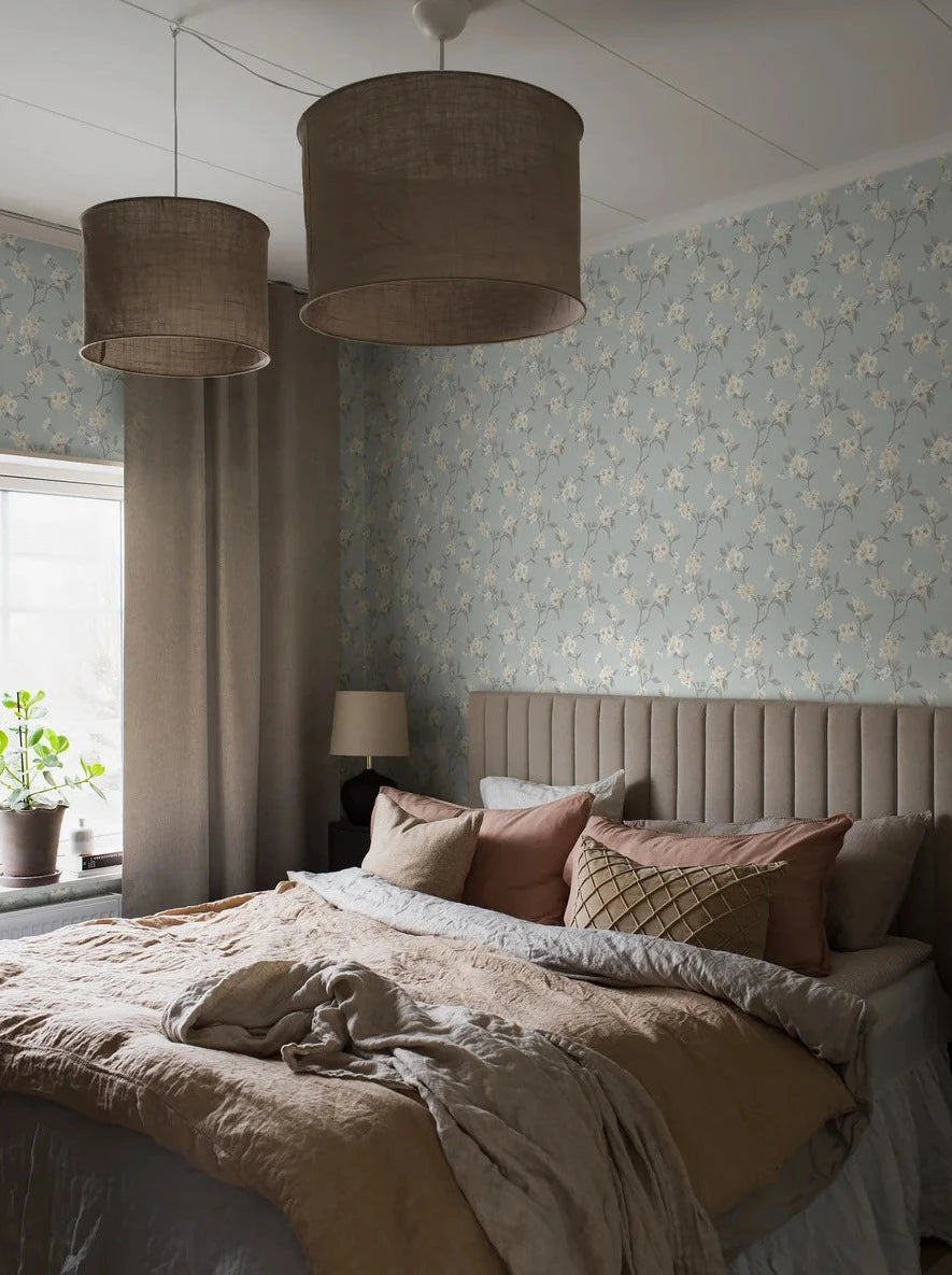 Colored in a dreamy palette on a pale blue background, our Marie wallpaper enchants your space with its watercolor-painted cherry branches.