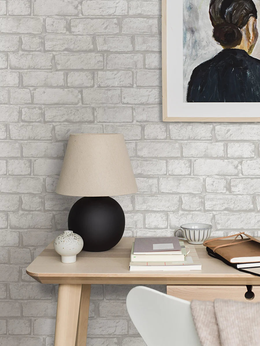 Colored in warm, grey shades, our Birk wallpaper with its cement, lime-like surface breathes a unique and inviting expression into your home.