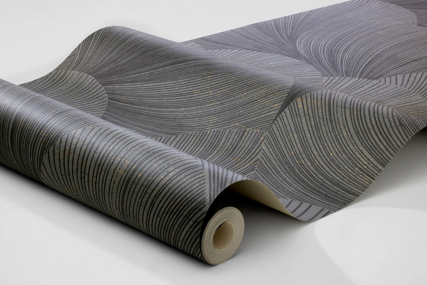 Colored in a dark and granite grey tones with contrasting hints of glittering gold, our Mirage wallpaper features a soft graphic pattern to match its chic and stylish palette.