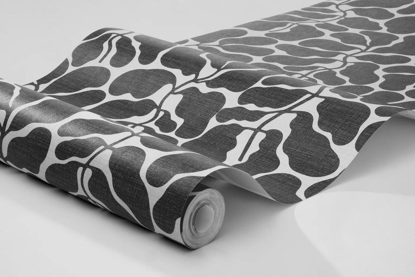 Escape to a tranquil oasis with the foliage pattern of My Secret Garden wallpaper in muted black tones on a crisp white background.