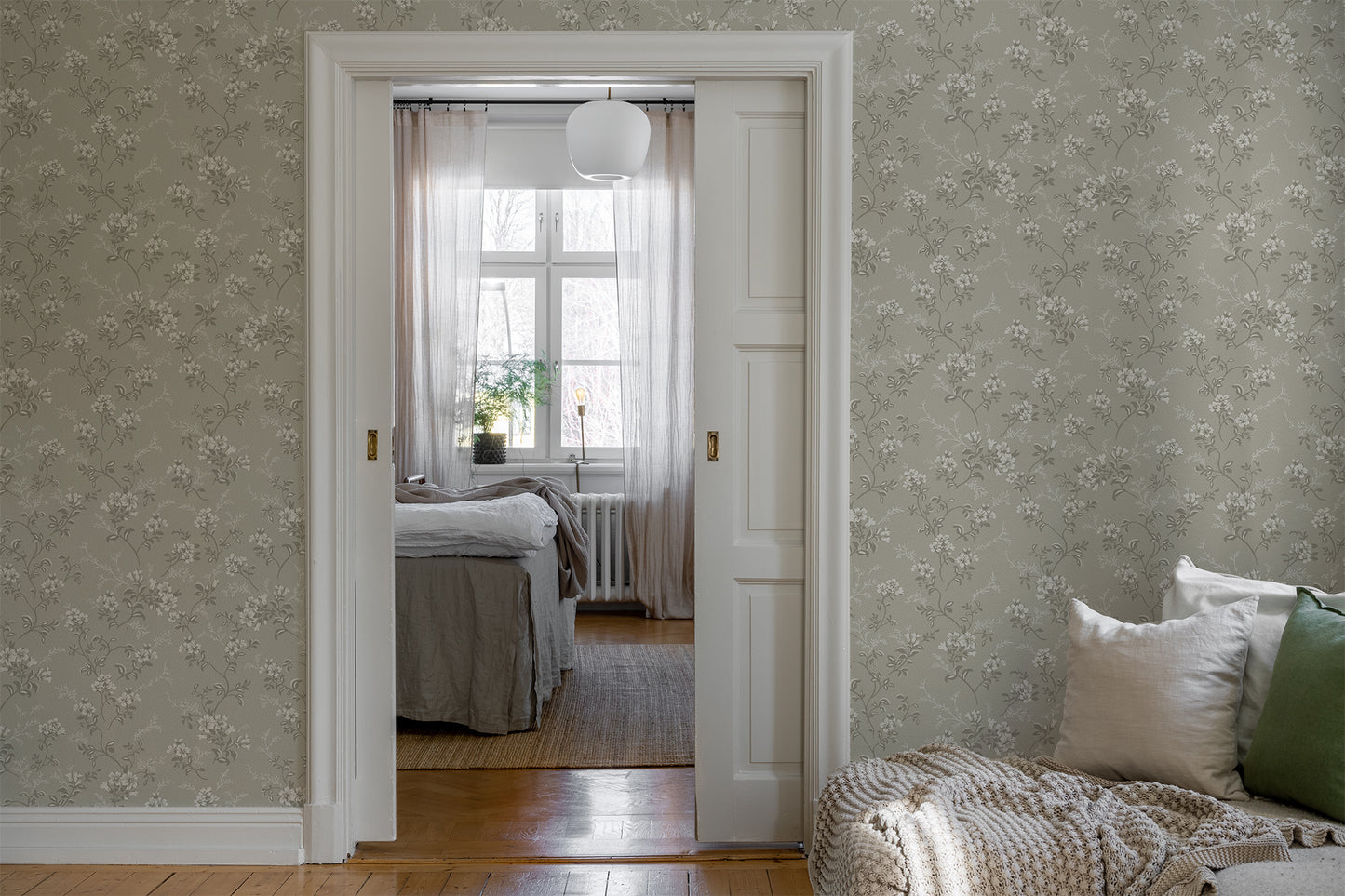Sonja is a classic floral wallpaper with a modern twist. Light flowers on stems and dots spread across the surface.