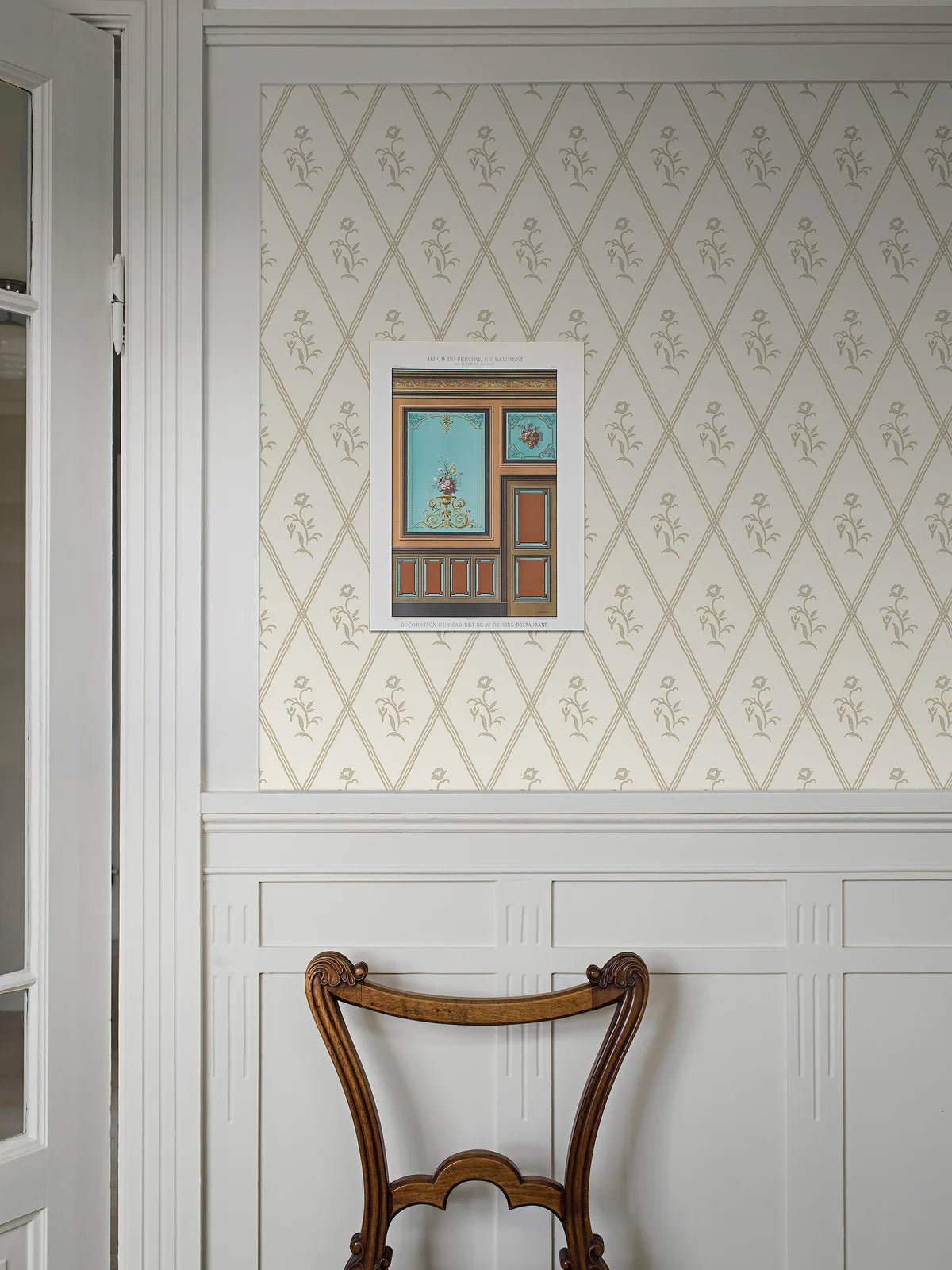 Featuring muted light blue flowers on a golden eggshell colored background, our Signe wallpaper in a collagraph print is timeless and elegant in its simplicity.