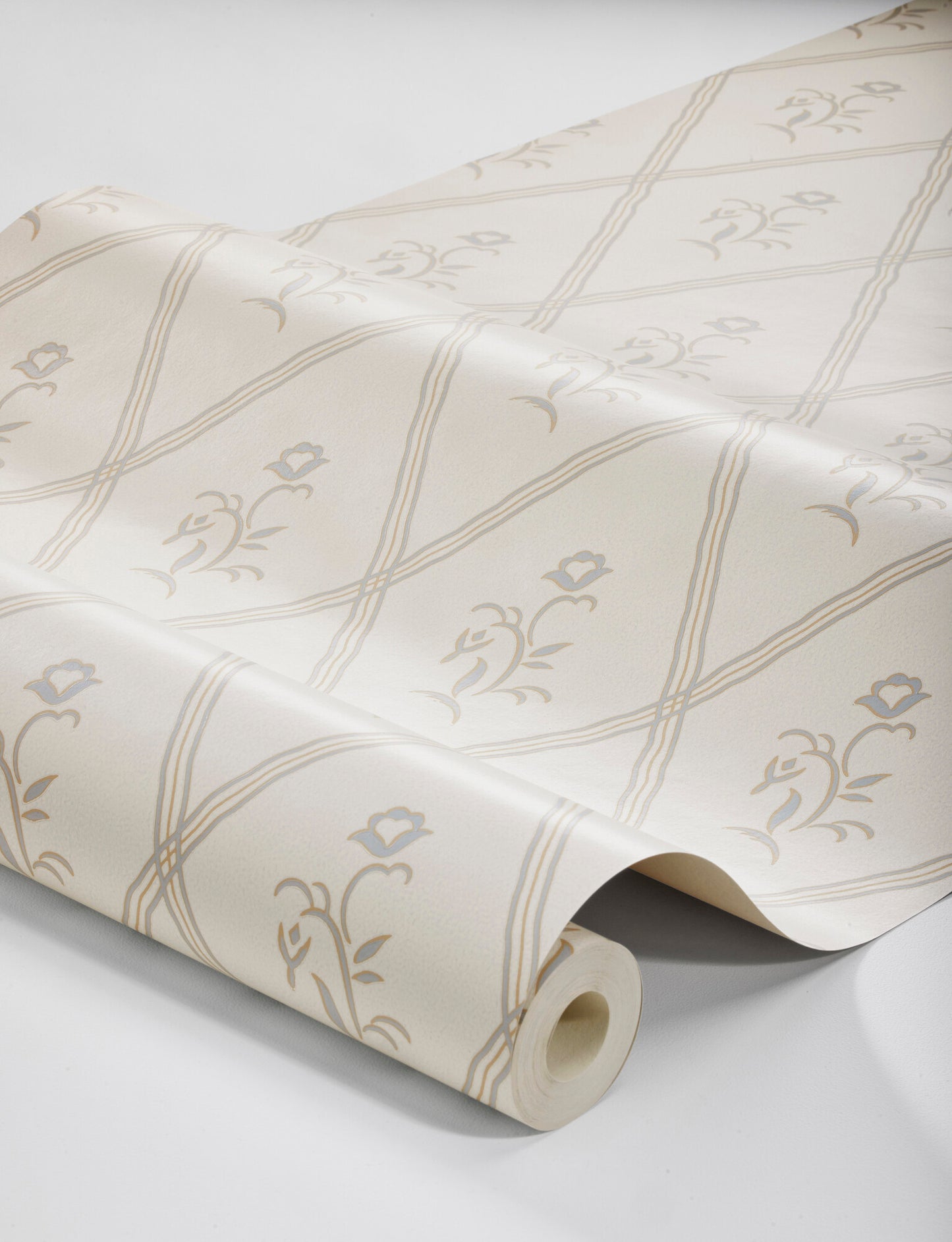 Featuring muted light blue flowers on a golden eggshell colored background, our Signe wallpaper in a collagraph print is timeless and elegant in its simplicity.