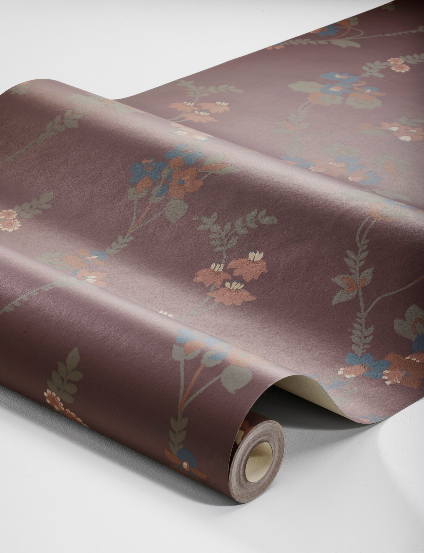 Set on a deep burgundy background with rusty red, pink, olive green and turquoise detailing, our Vera wallpaper is rich and indulgent.