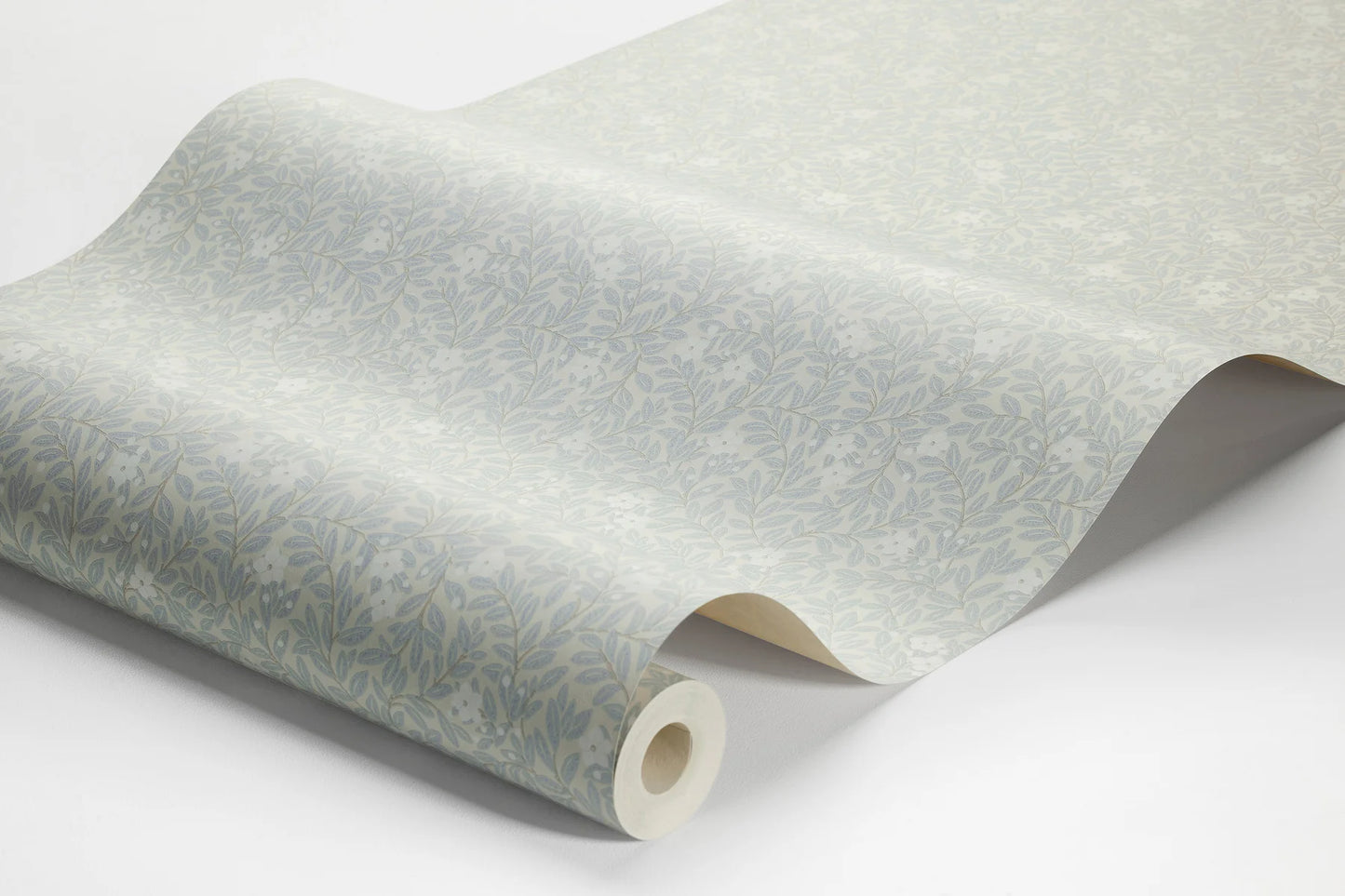 Step into a world of rustic charm with our Myrten wallpaper in a surface print. Colored in a palette of muted light blue, creamy white, and grey beige, it features a dense and decorative hand-painted floral and foliage pattern by Ulrica Hurtig.