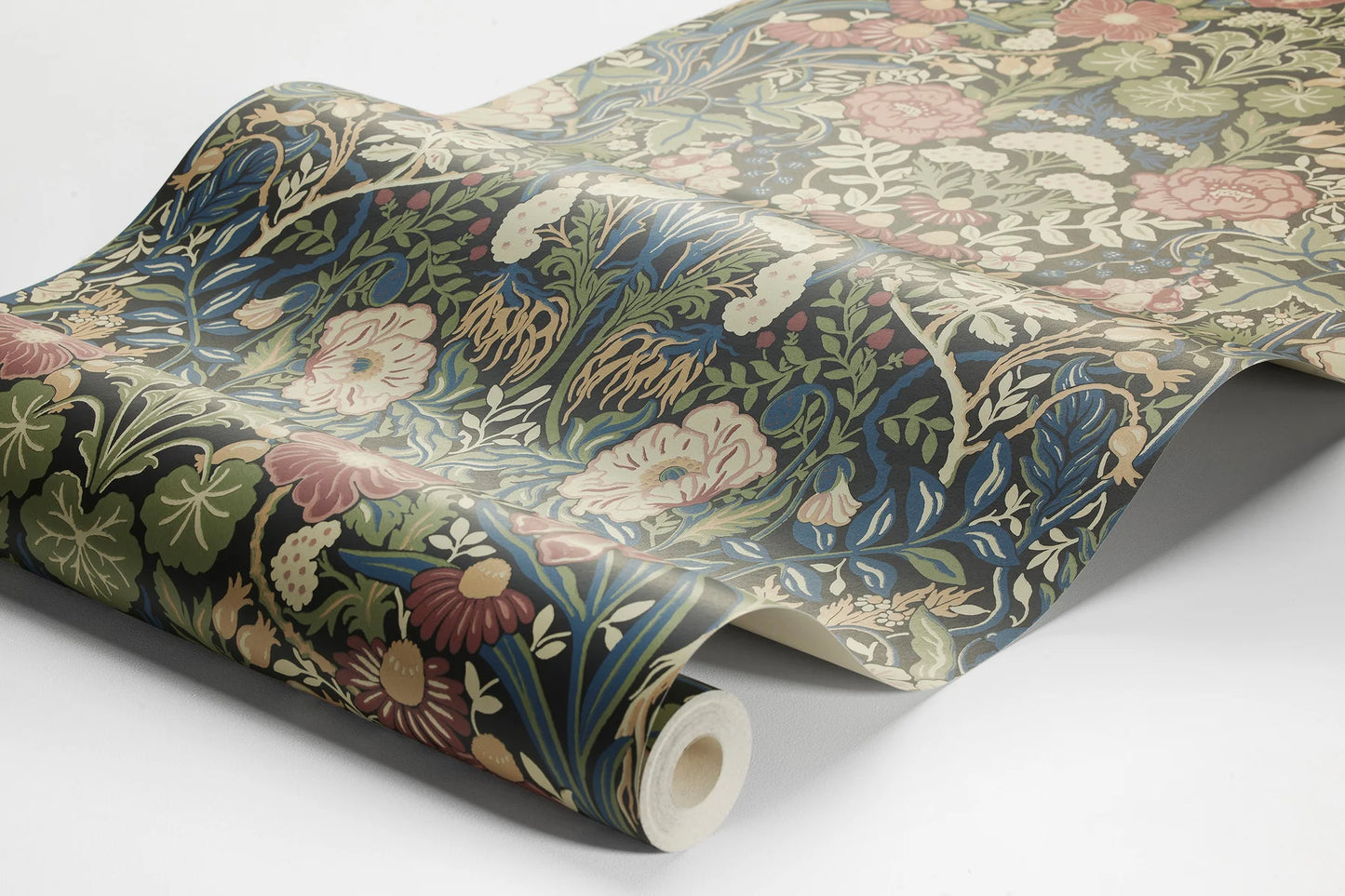 Immerse yourself in the traditional and classic charm of our Örtagård wallpaper in muted dark tones of burgundy, blue, olive green, yellow and cream on a bold black background.