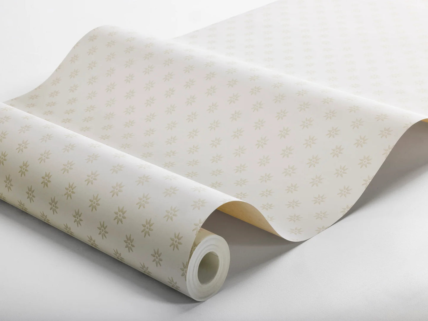 Subtle yet striking, our Skogsstjärna wallpaper pairs beige stars with a warm white background, reflecting the serene beauty of the springtime Swedish forest.