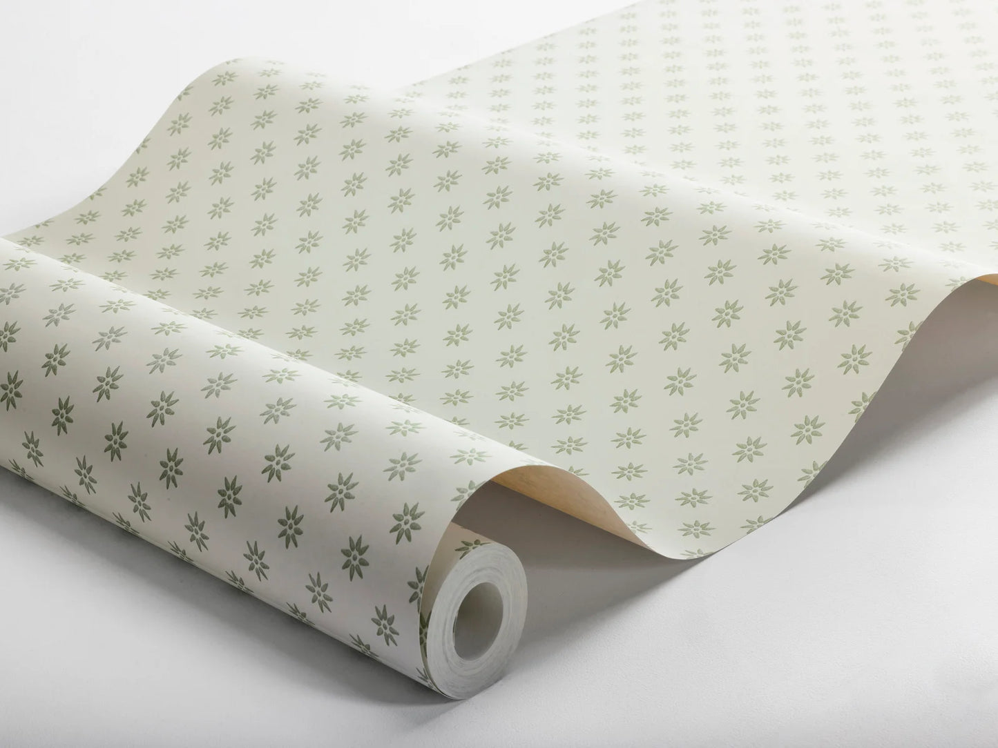 Subtle yet striking, our Skogsstjärna wallpaper pairs beige stars with a warm white background, reflecting the serene beauty of the springtime Swedish forest.