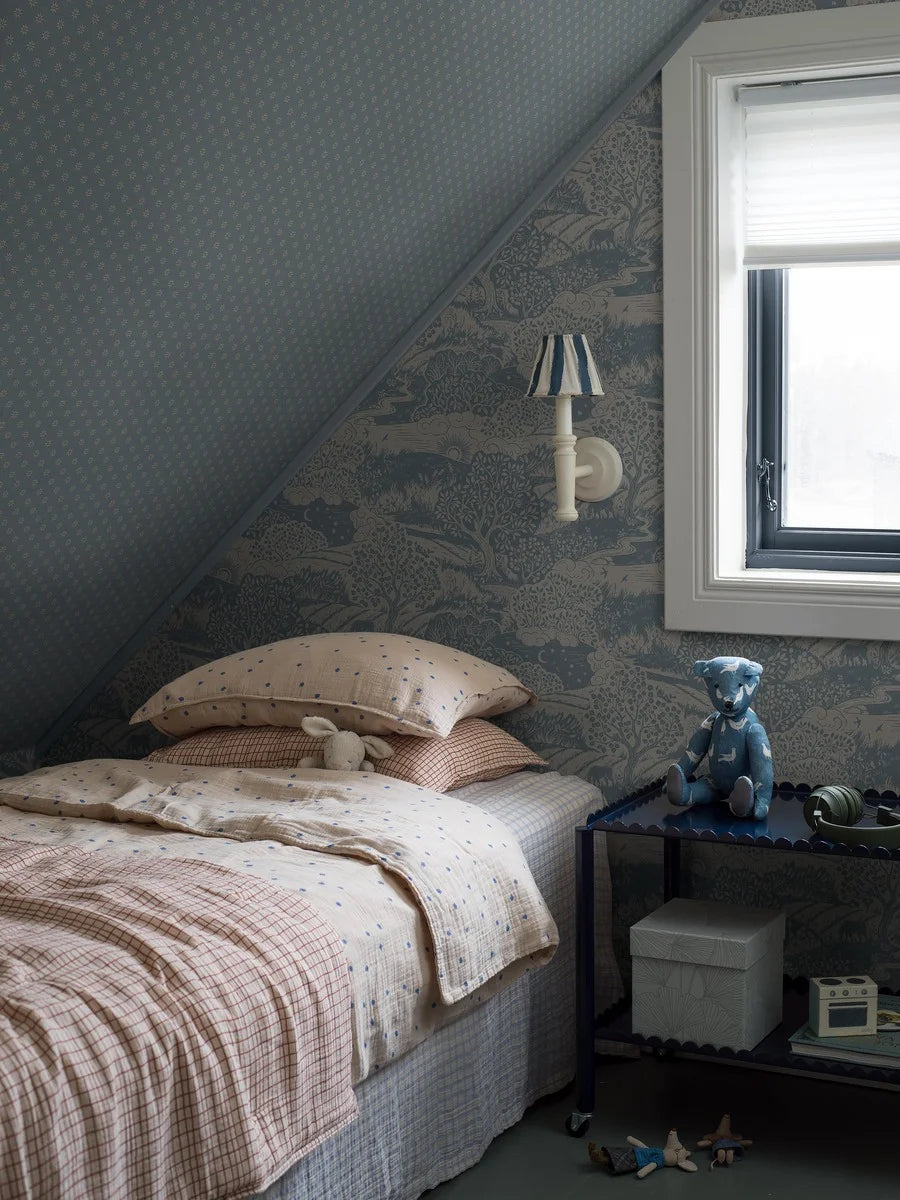 Colored in dove blue detailing on a linen grey background, our Solängen wallpaper offers a rich tapestry of natural beauty.