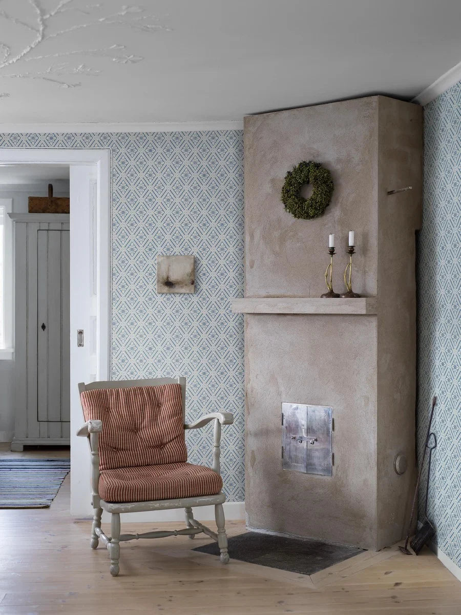 The wallpaper is coloured in a lovely palette of blue shades against a gentle creamy white background.