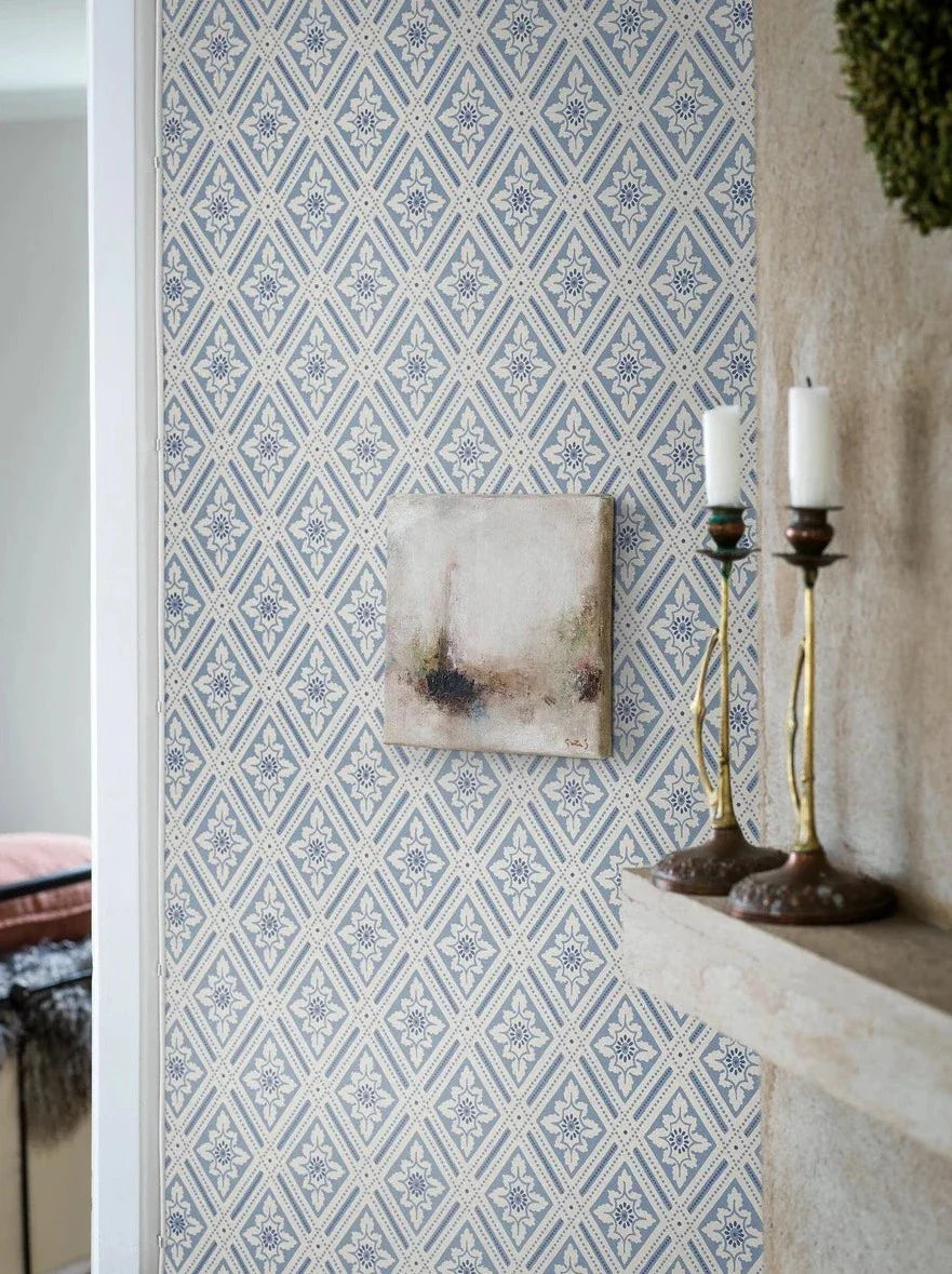The wallpaper is coloured in a lovely palette of blue shades against a gentle creamy white background.