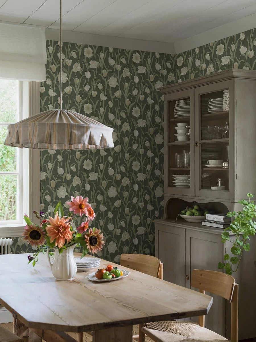 This gorgeous La Belle Epoque wallpaper displays cream-white tulips set against a fairly dark jade green background.