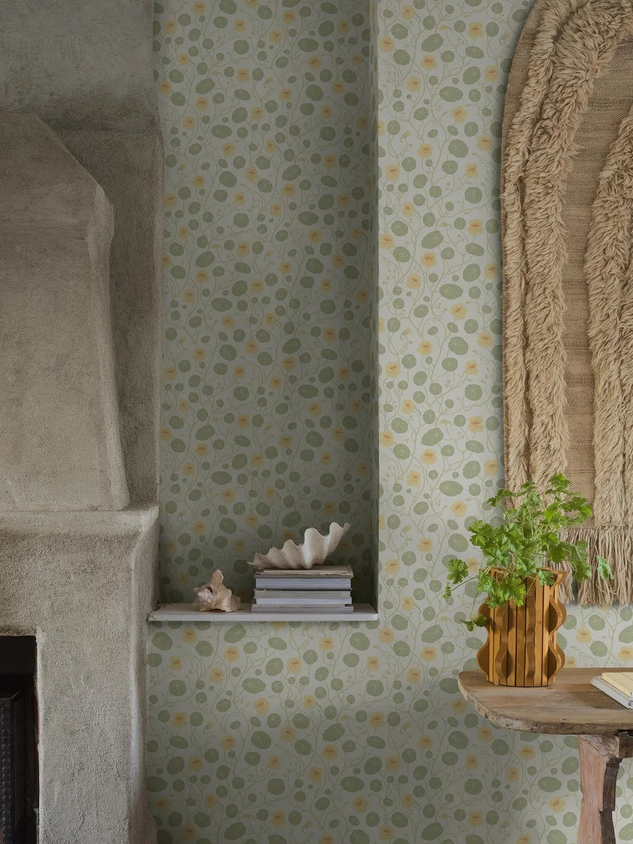 Krasse wallpaper is filled with cheerful Rock Cress flowers in bright yellow tones, with fresh green leaves and winding stems on a white background.