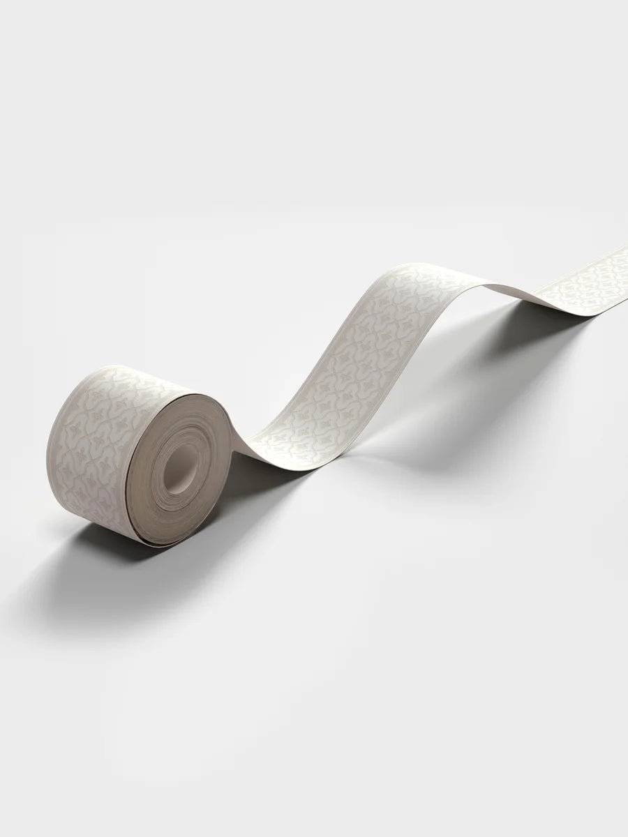 Featuring a dense yet subtle repeat geometric pattern, our Kalles Bård wallpaper border is colored in warm light beige tones and set on a fresh white background.
