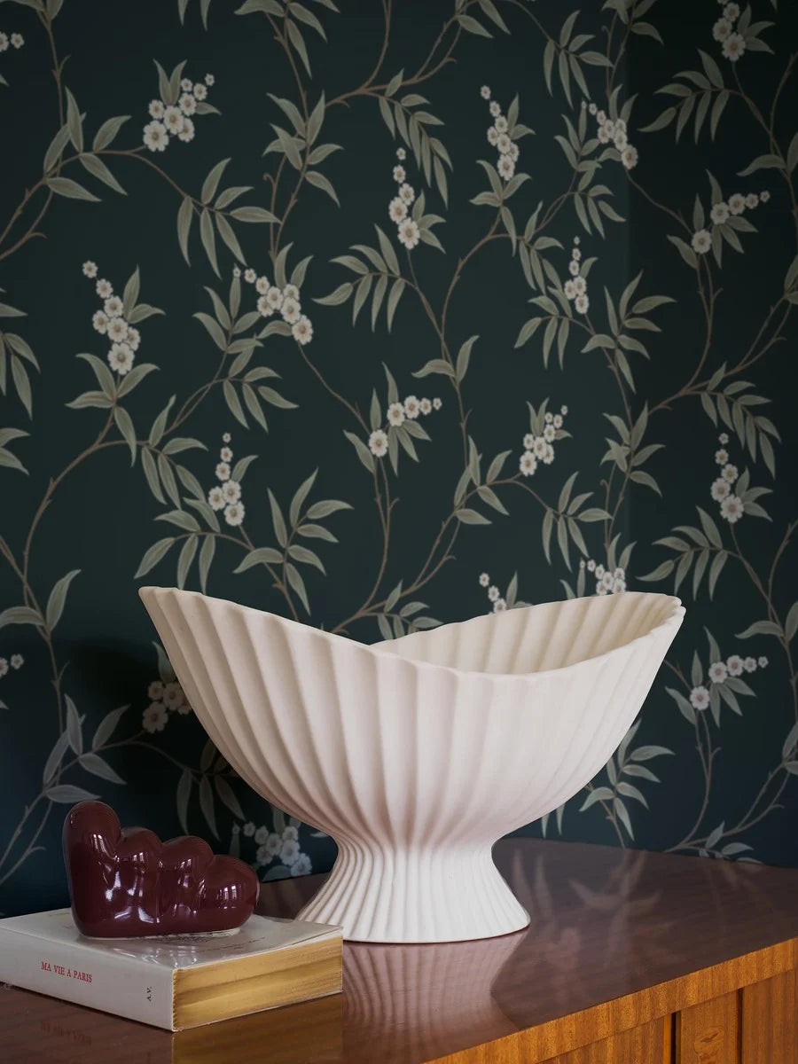 Our Floral Tree wallpaper pairs green leaves and white flowers with a charcoal black background, to create a bold, sophisticated design.