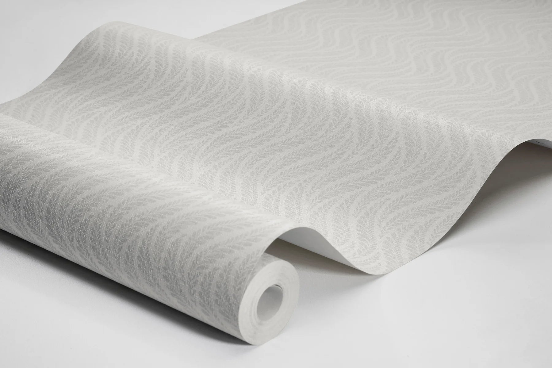 Colored in a soft white palette, our Little Fern wallpaper introduces a modern take on small-scale patterns with an understated elegance.