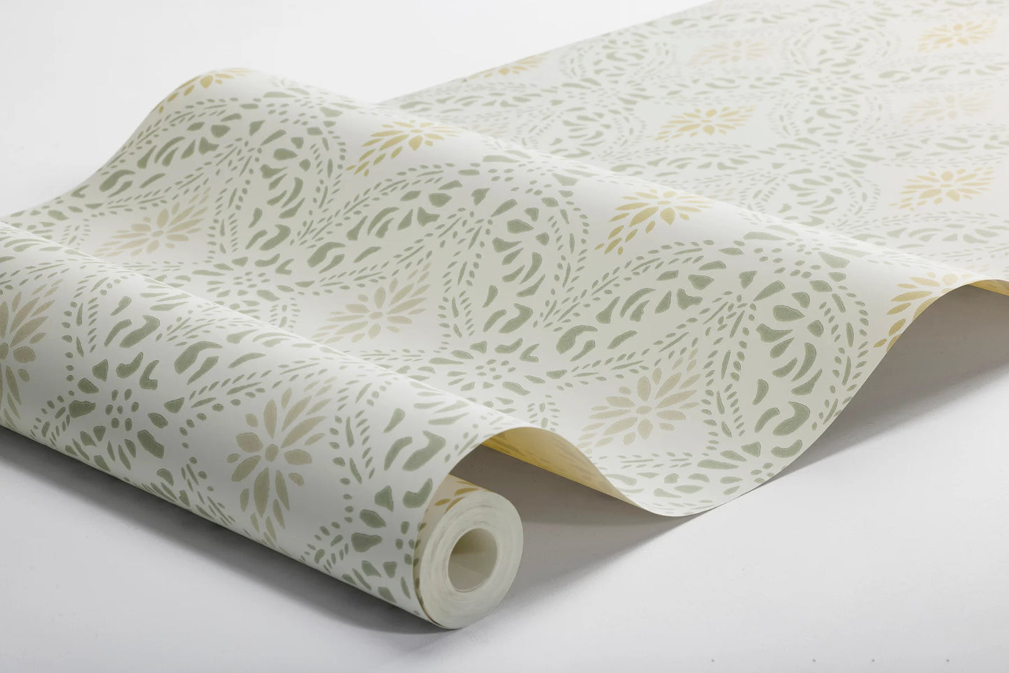 Colored in a bright yet cosy color scheme, our Kvarnholmen wallpaper features a stencil design, printed in soft green and ochre over a warm white background, with accents of sand-toned beige.