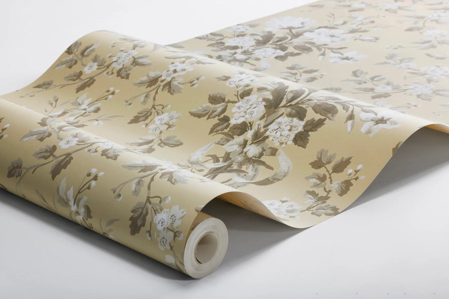 Colored in a muted yellow with beige and grey-brown detailing, our Tullgarn wallpaper brings graceful and royal elegance to your space.