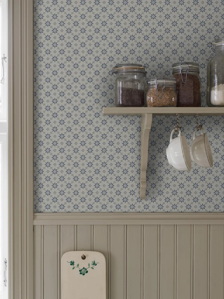 Set on a natural background with muted blue detailing, our Stella wallpaper balances structure and whimsy perfectly.