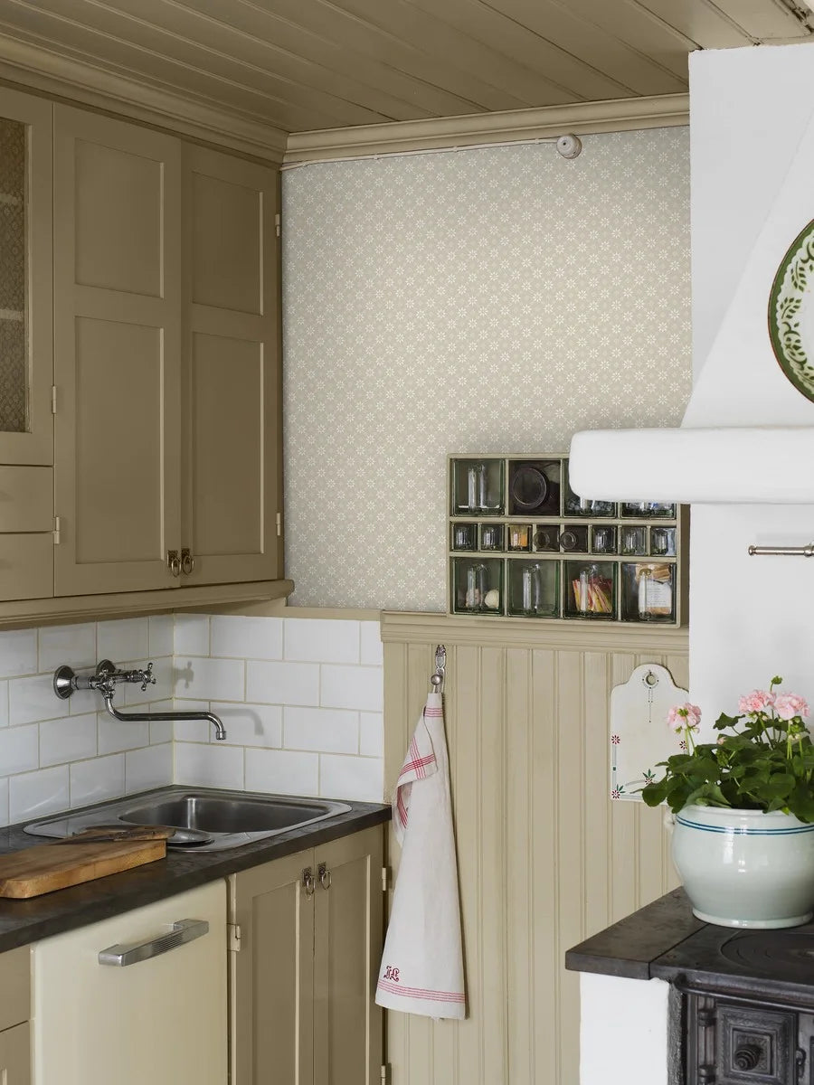Soft white stars brighten a natural background in our Stella wallpaper to create a clean and understated palette.