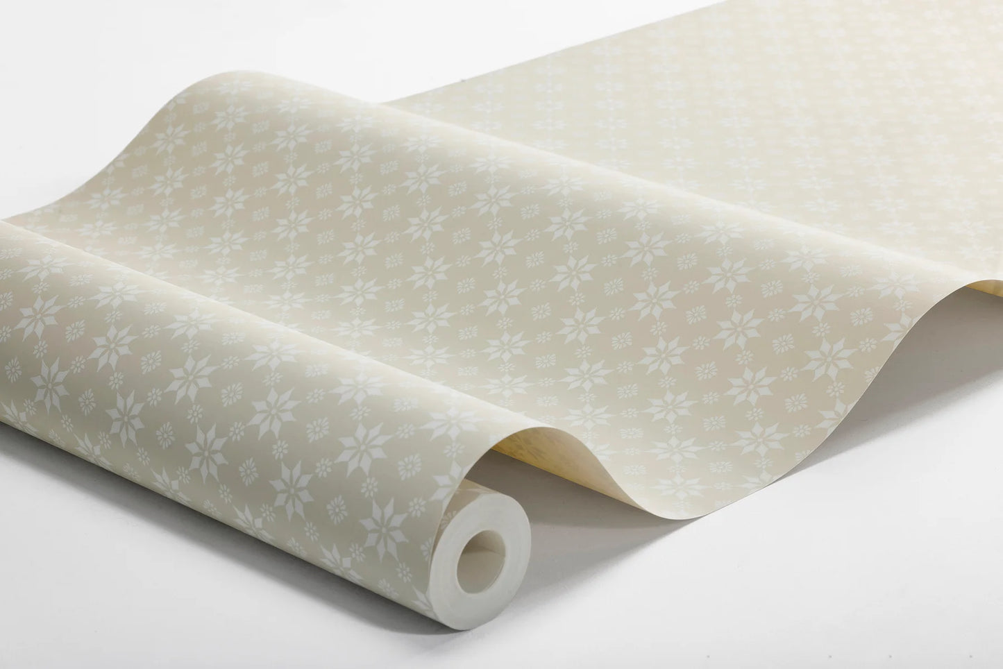 Soft white stars brighten a natural background in our Stella wallpaper to create a clean and understated palette.