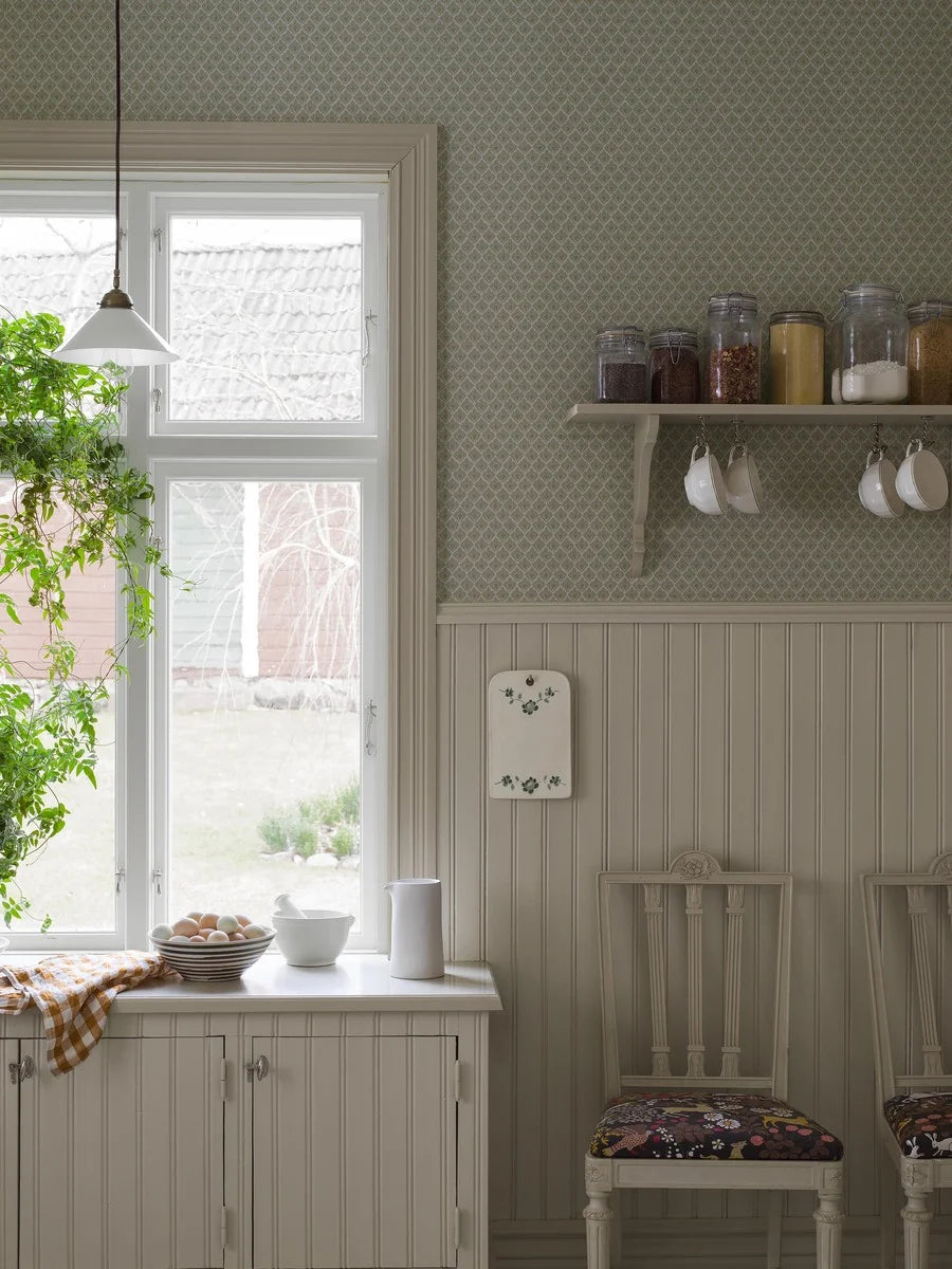 Understated, yet full of character, our Svea wallpaper is colored in a muted green palette lifted by ochre highlights that add a touch of warmth.