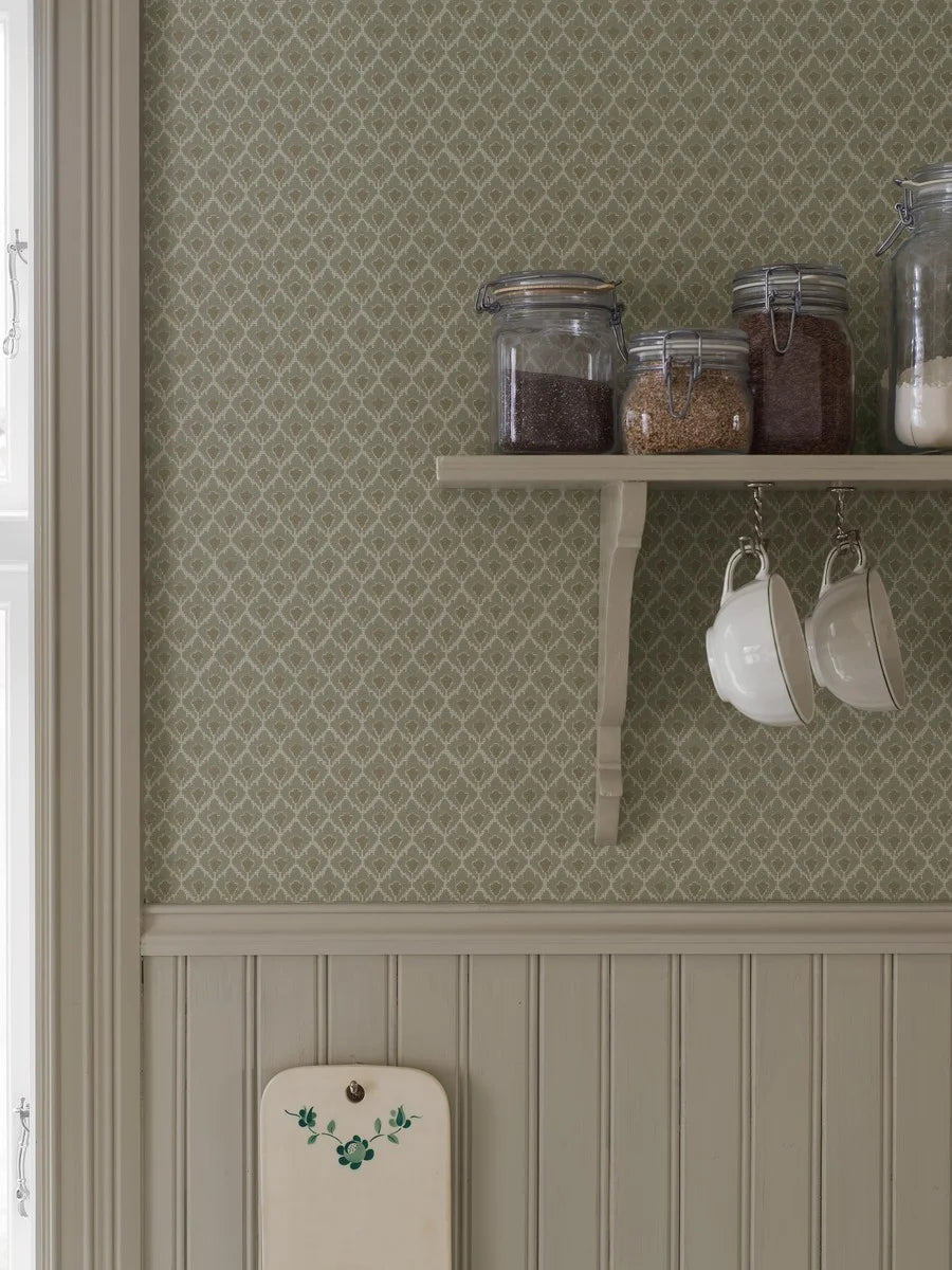 Understated, yet full of character, our Svea wallpaper is colored in a muted green palette lifted by ochre highlights that add a touch of warmth.