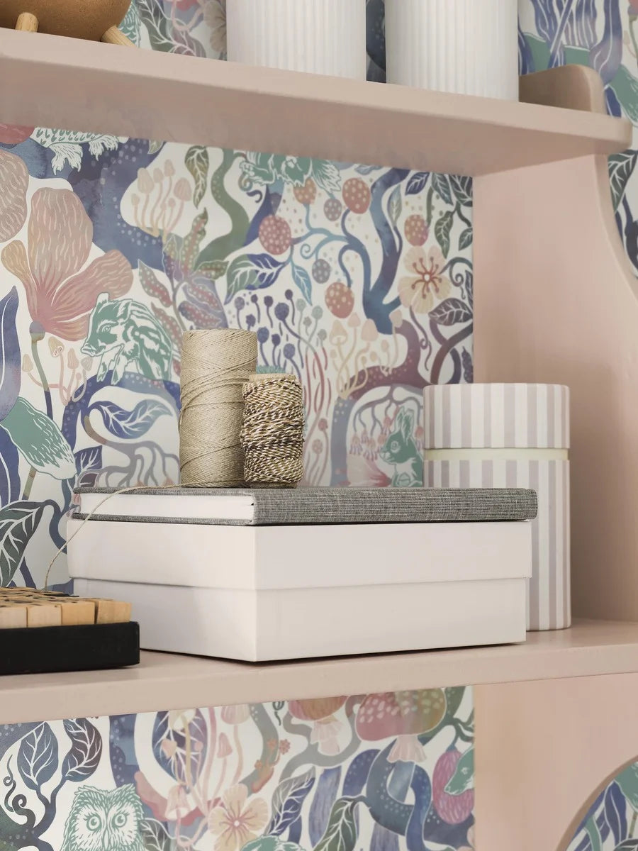 Our Magic Woods wallpaper features a dreamy woodland design in soft multi-colored pastel hues on a warm white background.