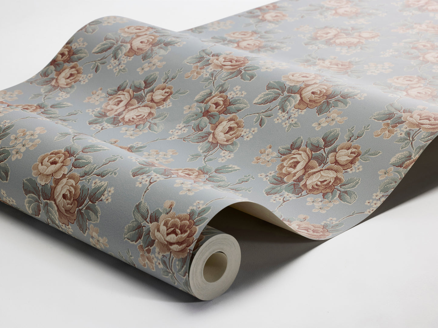 Colored in a soft sky-blue tone, our Helena wallpaper reprints a romantic archival rose design with clusters of blooms detailed in apricot, petrol blue, and cream-white.
