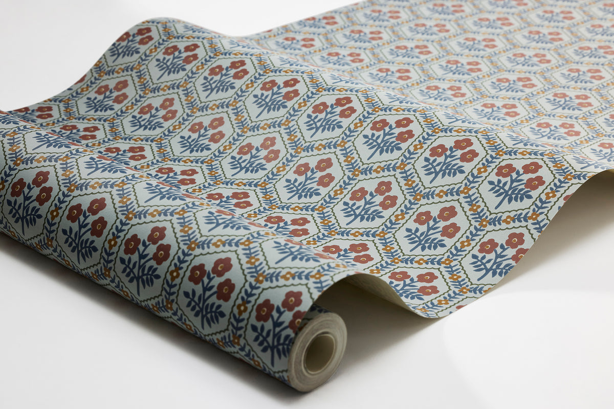 Cecilia is a small-scale floral wallpaper with a rhythmic pattern of sweet little flowers framed by geometric floral garlands.