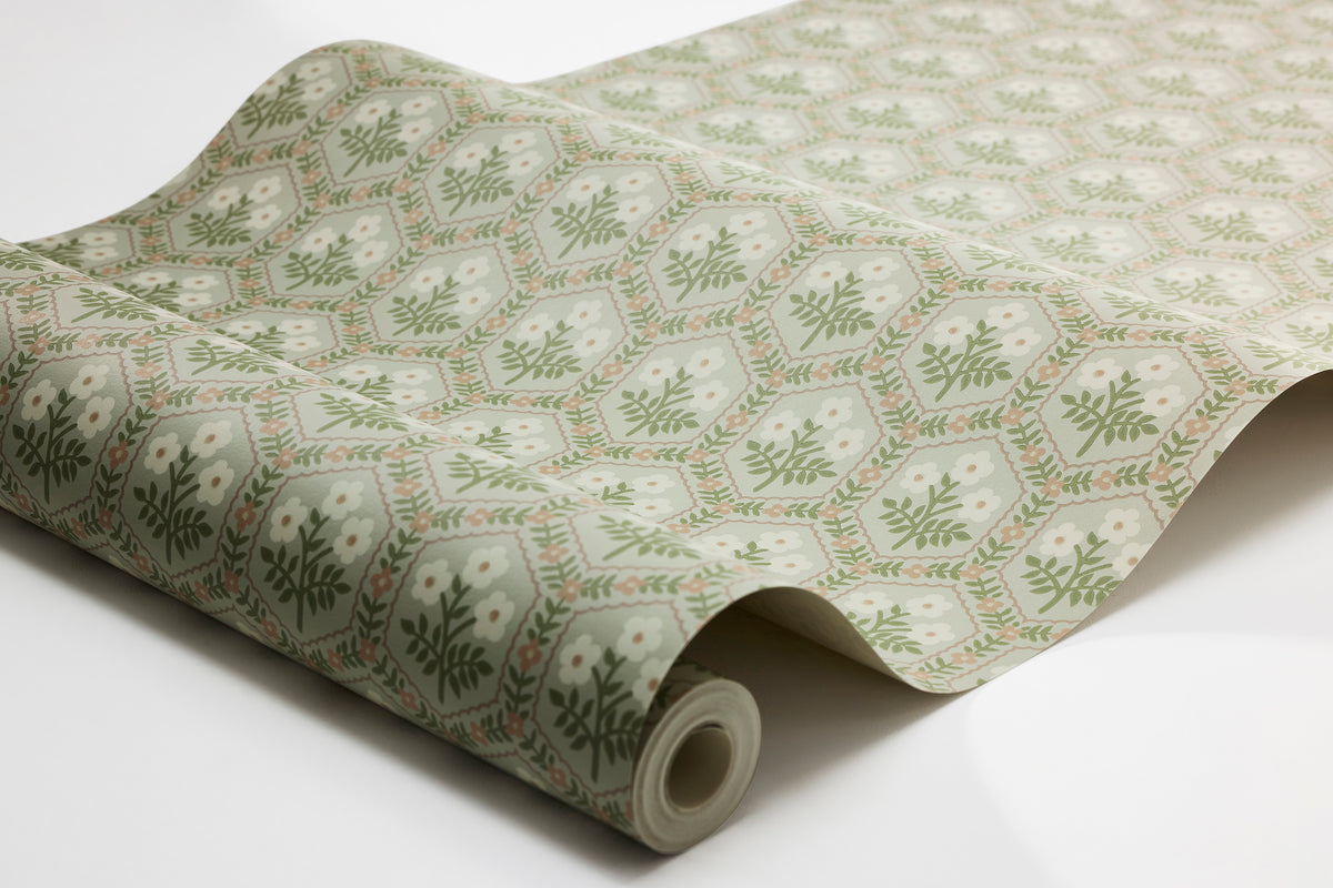 The Small-scale wallpaper Cecilia's cute, geometric floral pattern is created with inspiration from a furniture fabric from the first half of the 20th century.