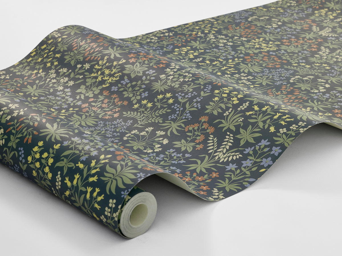 Abundant sweet meadow flowers adorn the dark, small-floral wallpaper Vildflora.