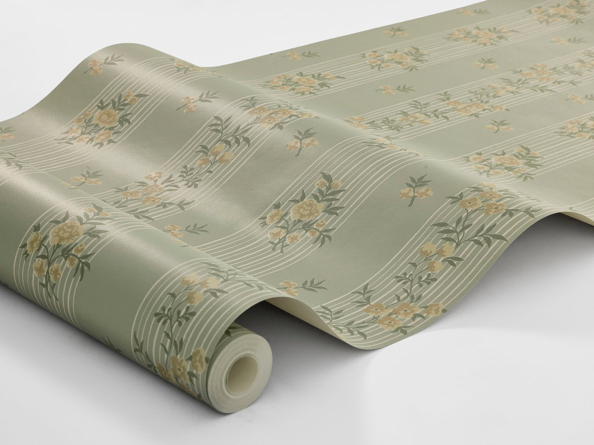 The Striped wallpaper Hufvudsta Gård combines romantic charm with the light, airy expression of the Gustavian style. Here, beige flowers with green leaves wind across light beige stripes – all set against a softly warm green background.