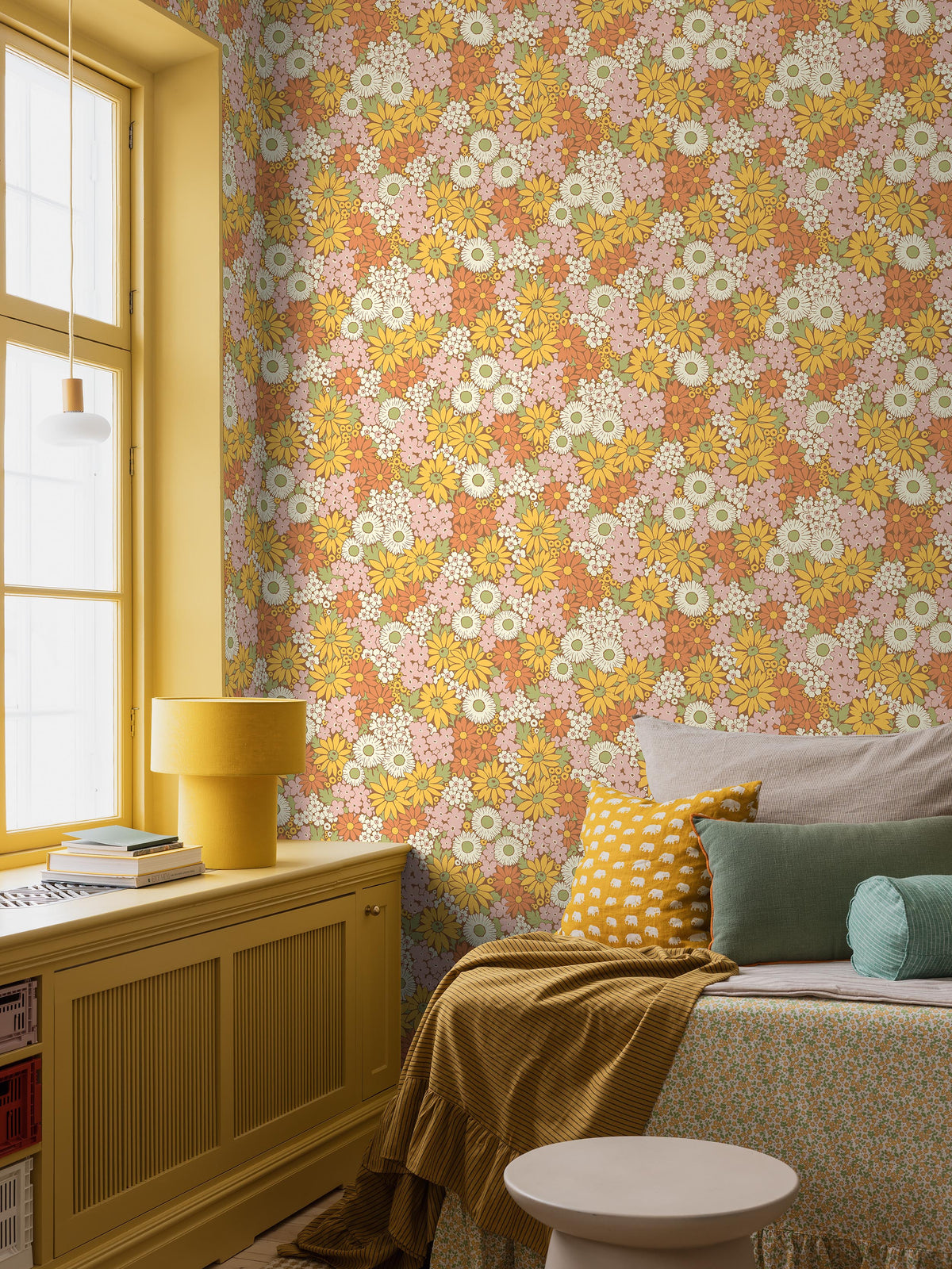 The Floral 1970s wallpaper Flower Power, with its riotous sea of blooms, is taken from our historical archive. A hand-painted pattern featuring, among others, marigold, coneflower, and black-eyed Susan in warm shades of sunny yellow, Orange, Pink, white, and green against a spicy cinnamon-brown background.