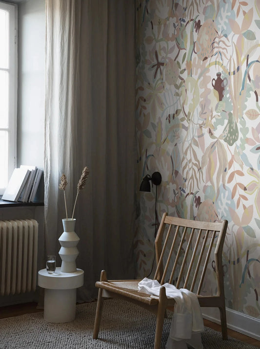 The harmonious Gingerlily wallpaper depicts a hand-painted fantasy tree in soft pastel shades, drawing inspiration from 20th-century Scandinavian artists. 