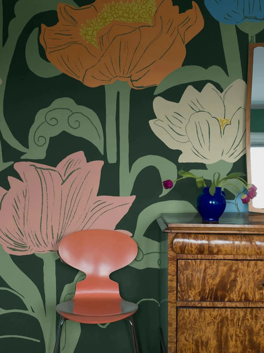 Set against a background of rich muted green, Astrid Wilson’s hand-painted Buttercup pattern showcases a large-scale design with a modern feel.