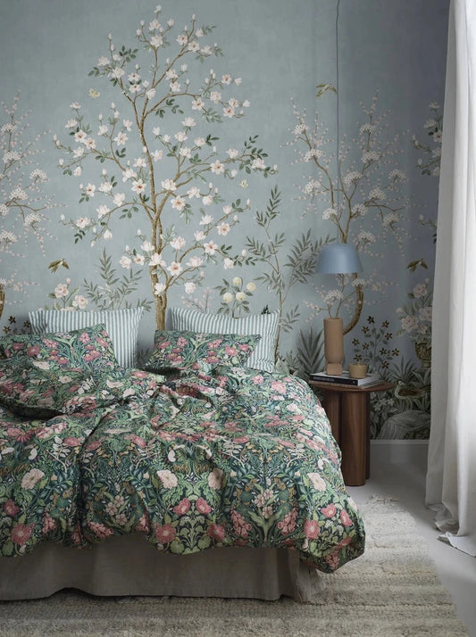 The richly decorated wallpaper Magnolia Garden is adorned with a magical garden in full bloom, with beautiful birds and fluttering butterflies.