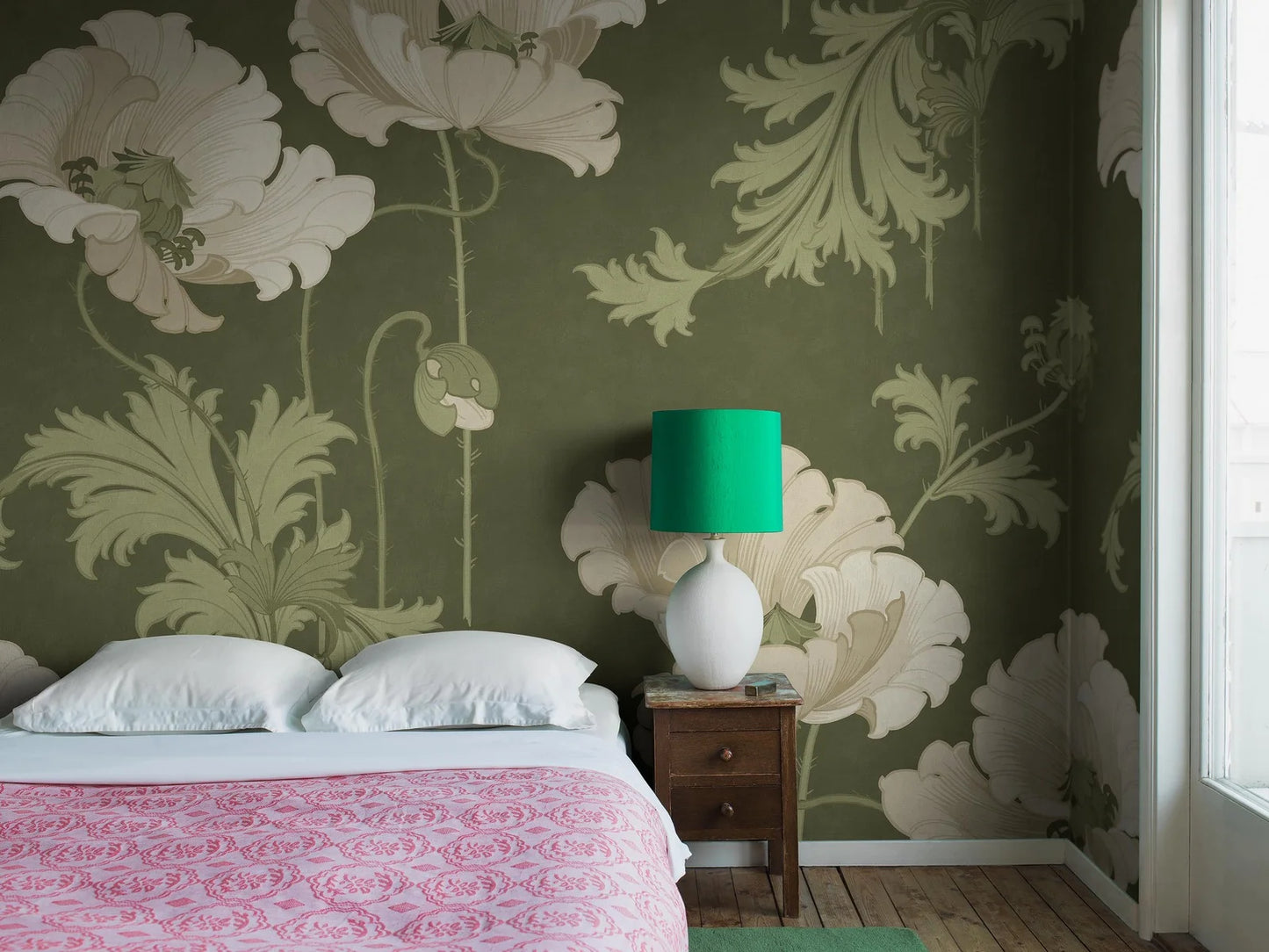 This Vallmo mural wallpaper is adorned with large, warm white flowers with fresh green leaves, buds and seed pods on a deep dark green background.