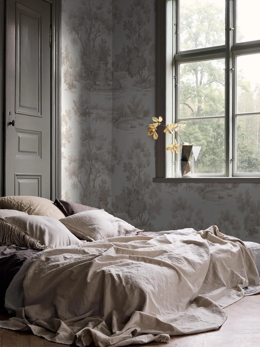 Grisaille is a light, decorative wallpaper with a stylized landscape motif in grey-beige tones on a white background.