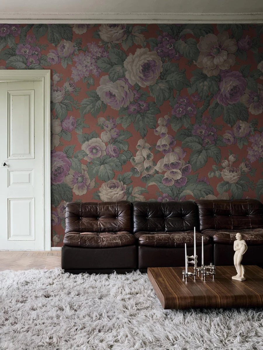 The large-flowered wallpaper Rose Magnifique is covered in roses, foxgloves, and other blooms in a lively, lush pattern