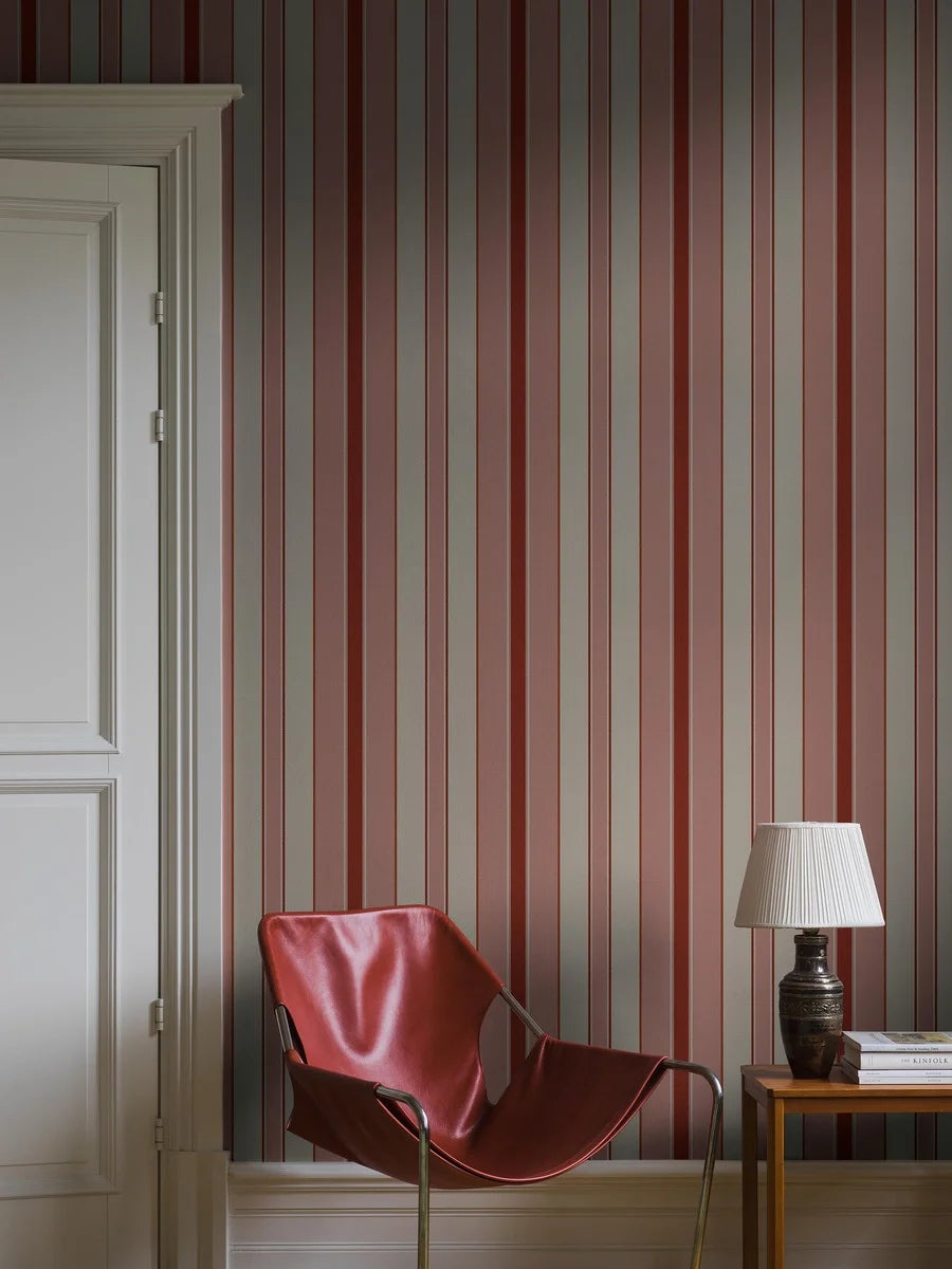 Stockholm Stripe is a striped wallpaper featuring stripes of varying widths and colors – a playful approach that brings delightful dynamism to the timeless pattern.