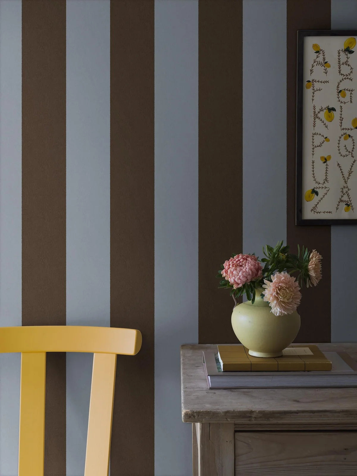 The wide-striped Båstad Stripe wallpaper feels modern and perfectly on trend, with its broad block stripes in dove blue and dark brown.