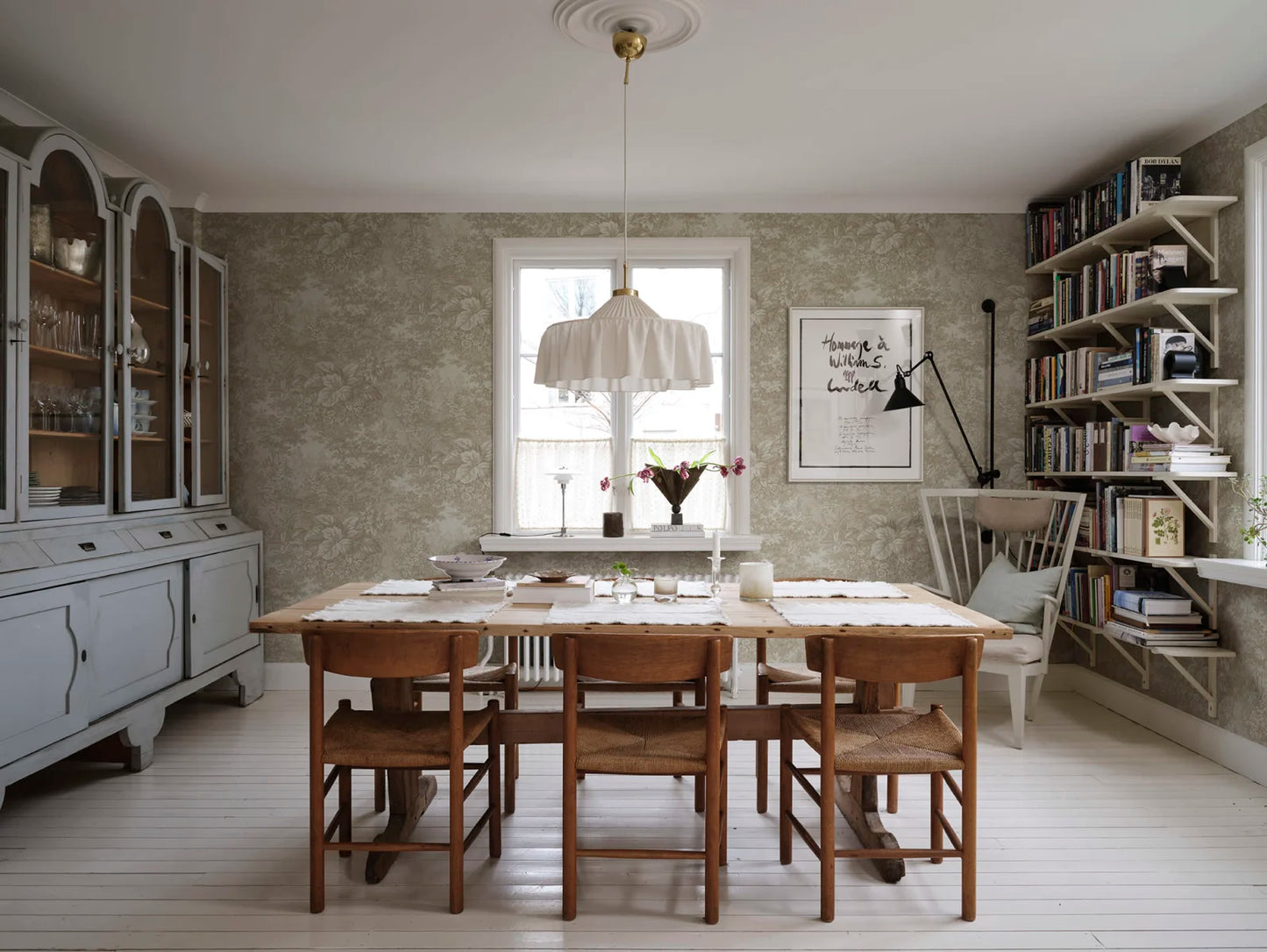 Based on a textile print from 19th century France featuring lush forest clearings that lay the wallpaper like an embracing blanket over the walls.