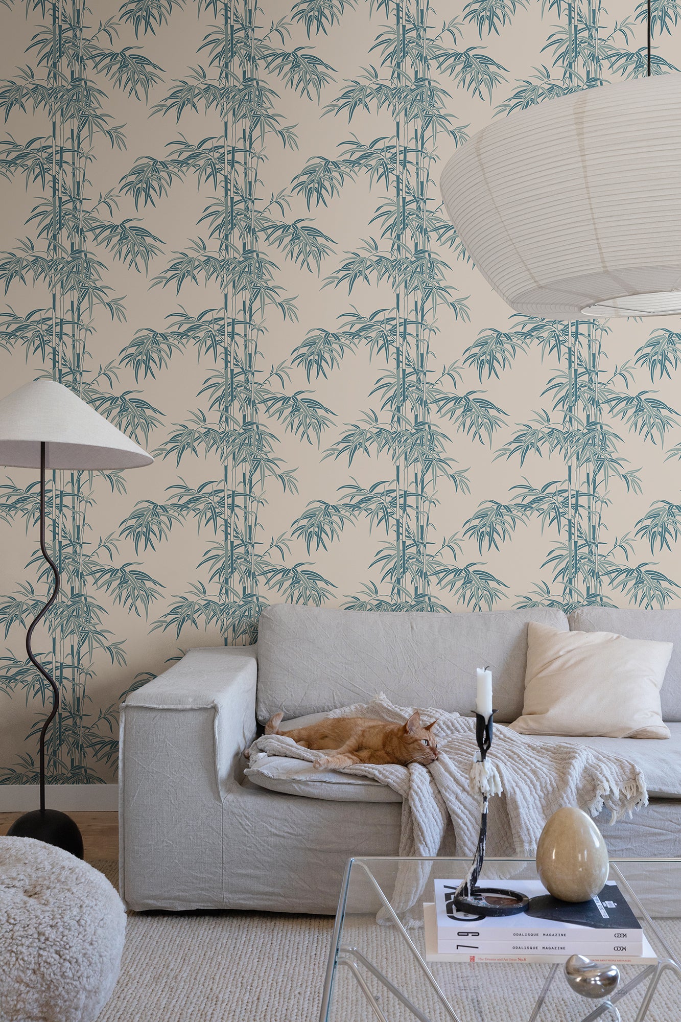 The wallpaper Leon, Misty Blue showcases a soft beige background highlighted with cool blue and green hues.