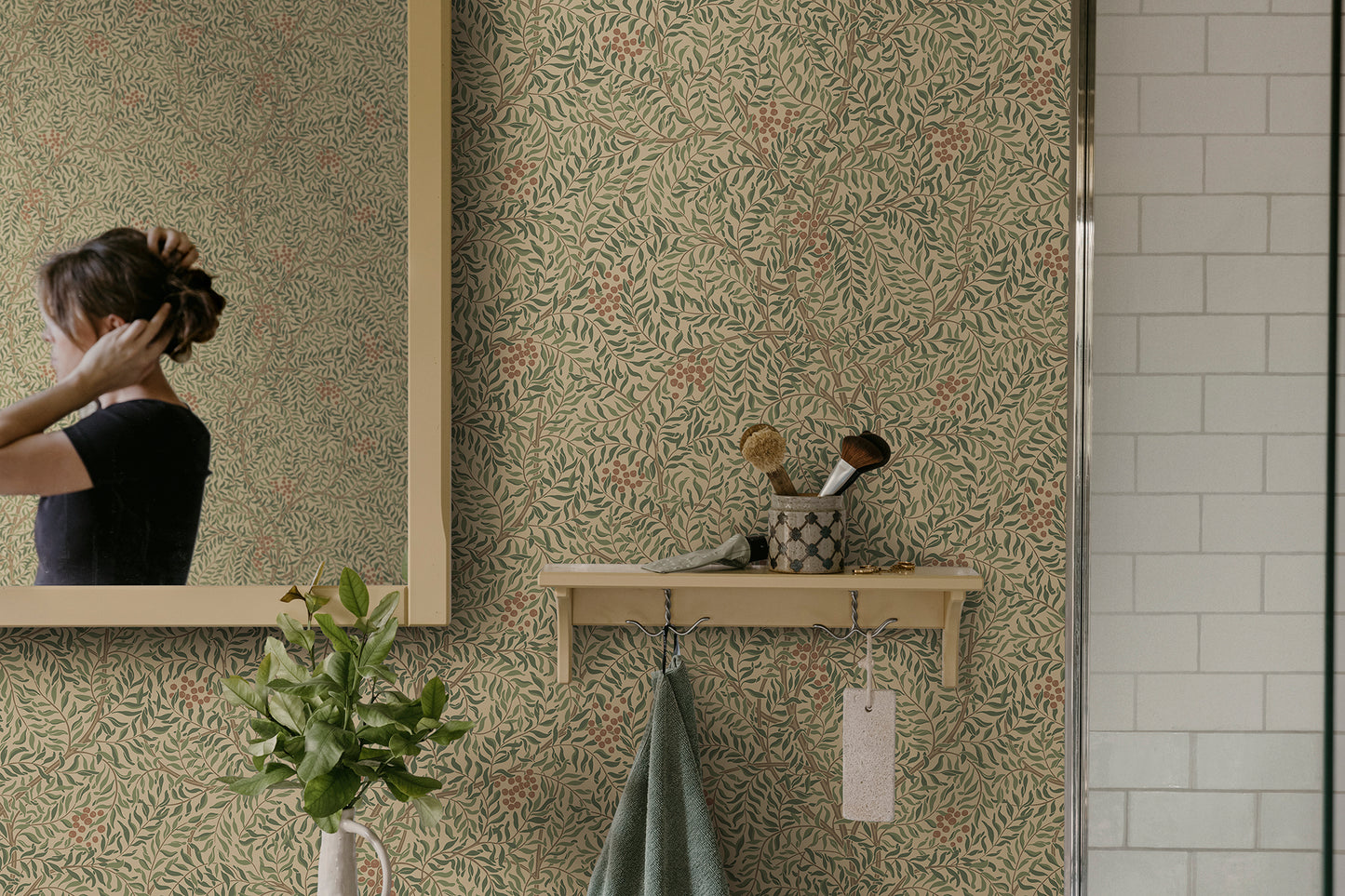 A harmonious surface-printed wallpaper pattern featuring intricate rowan berry branches creates a cozy and welcoming atmosphere with its stylized and enveloping design.