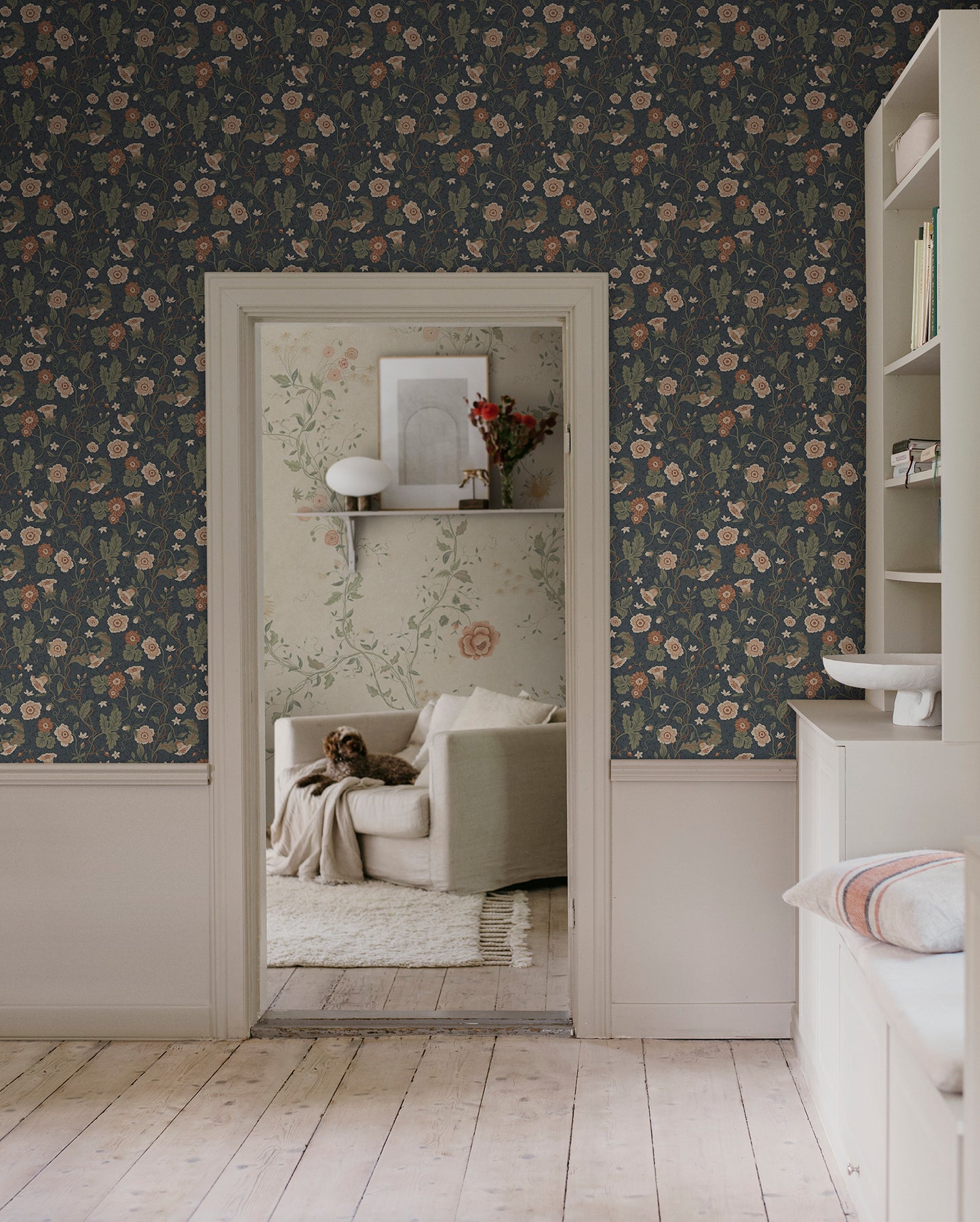 Japanese anemones, cup-and-saucer vines, and avens intertwined offer a softly verdant Arts & Crafts-inspired wallpaper with intricate details and an enveloping character.