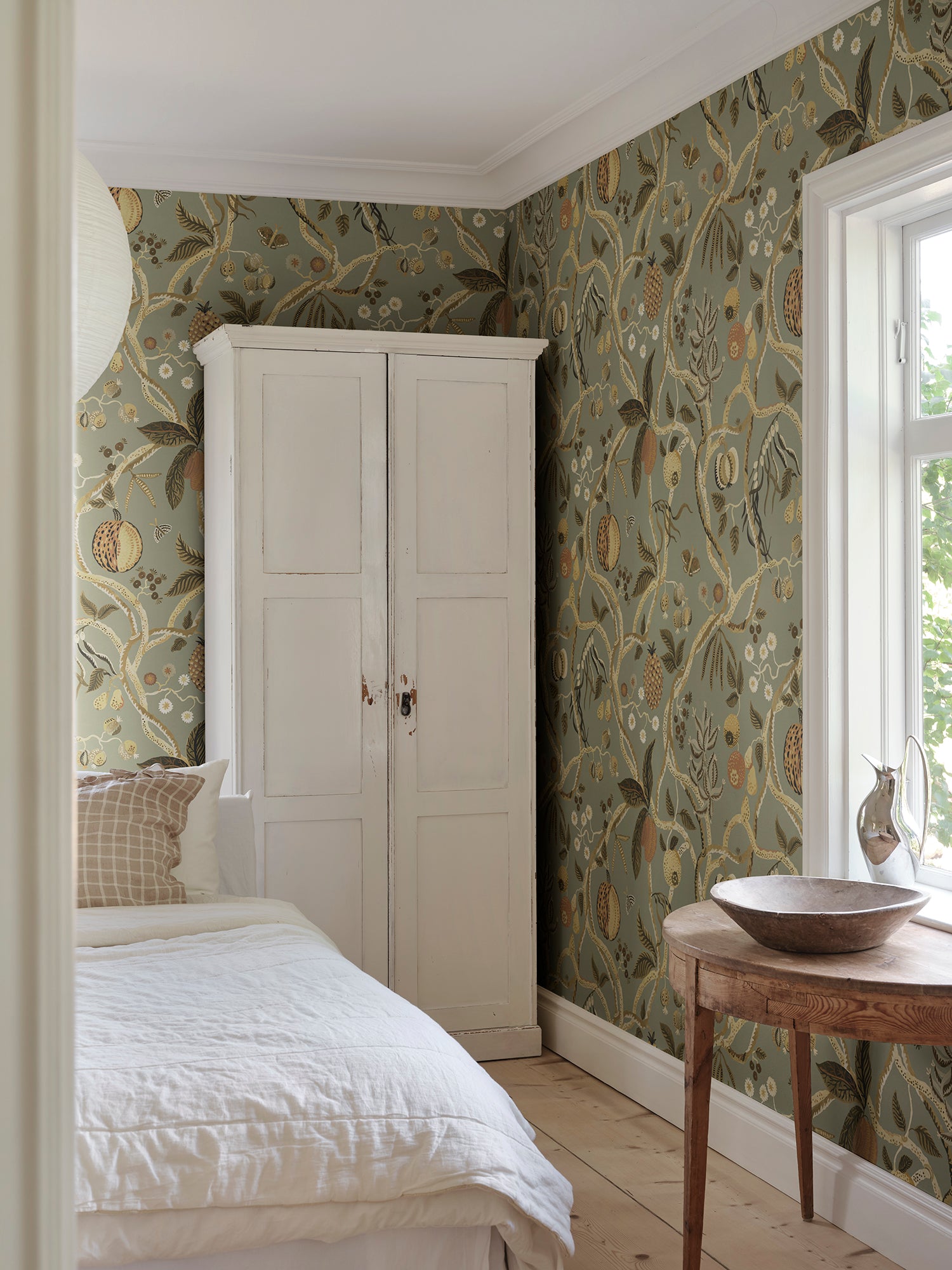 A wallpaper with a playfully hand-painted fantasy tree inspired by plants from Plantae Selectae, adorned with intertwining decorative fruits.