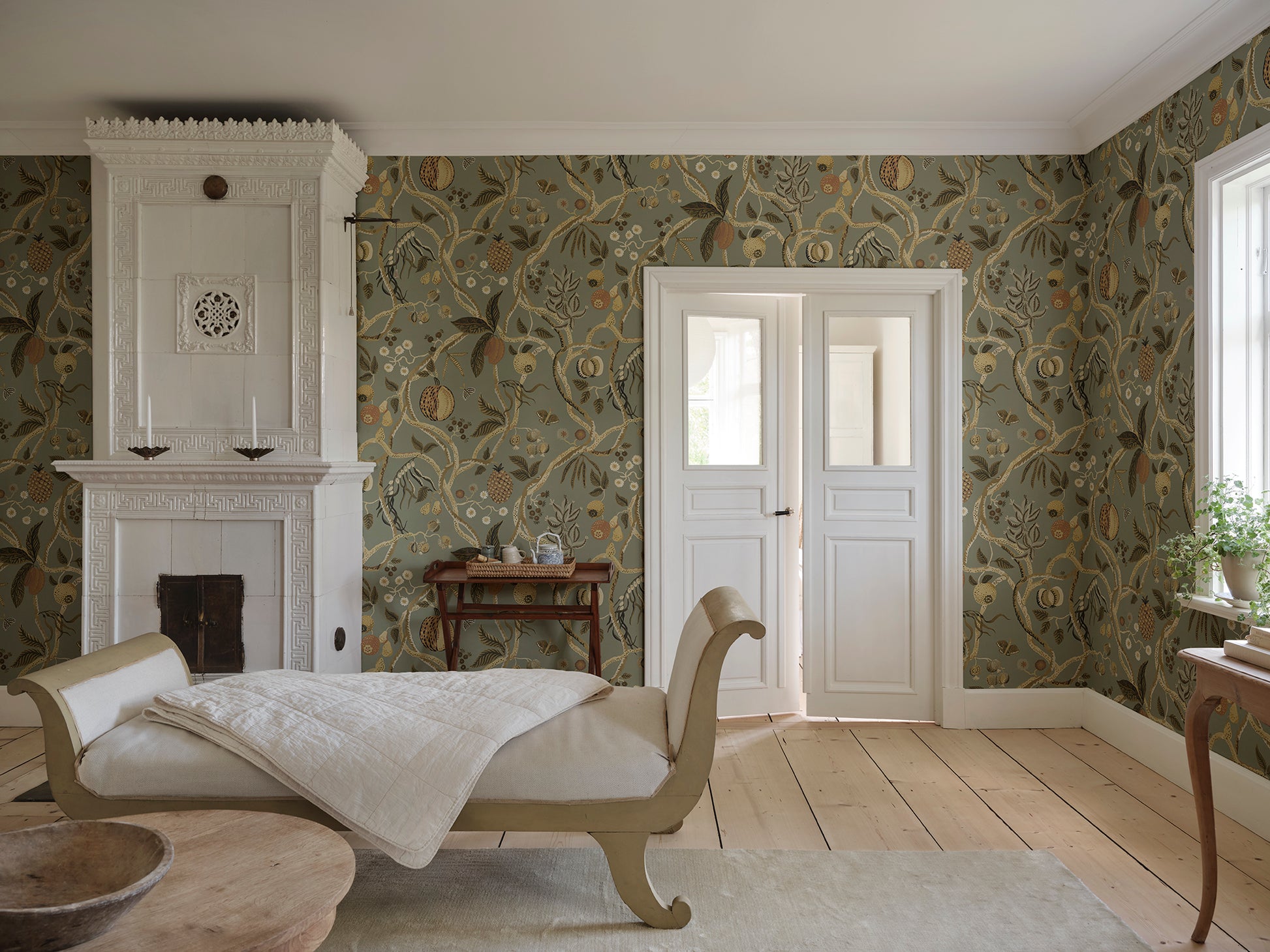 A wallpaper with a playfully hand-painted fantasy tree inspired by plants from Plantae Selectae, adorned with intertwining decorative fruits.