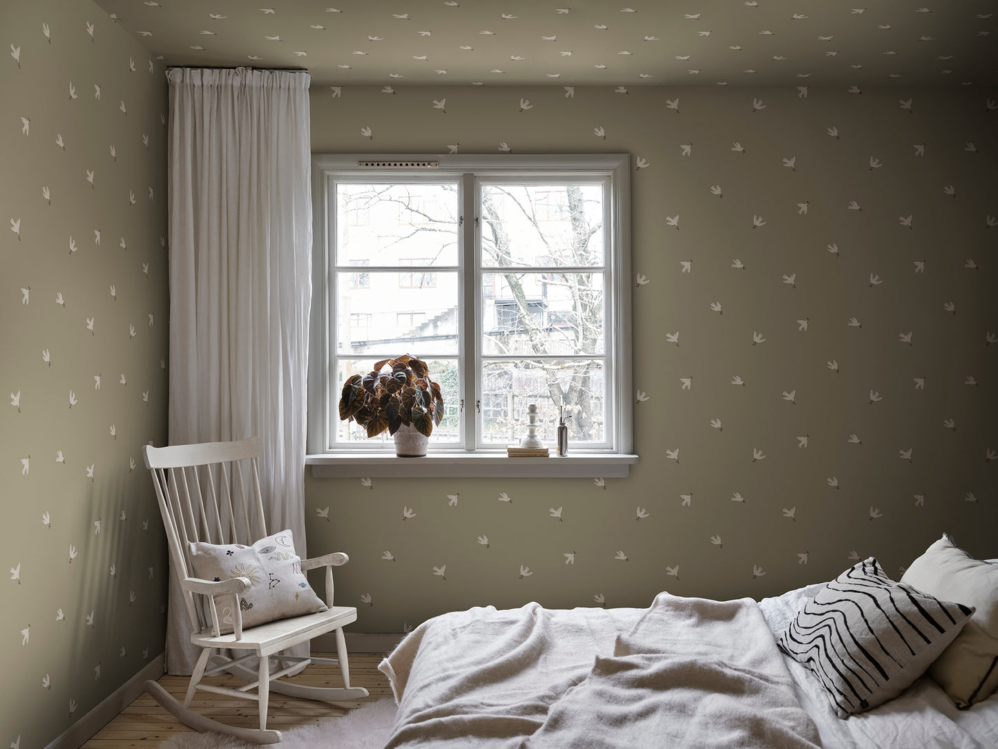 The Frida wallpaper creates a sanctuary of peace with gentle doves of peace in an olive green canvas.