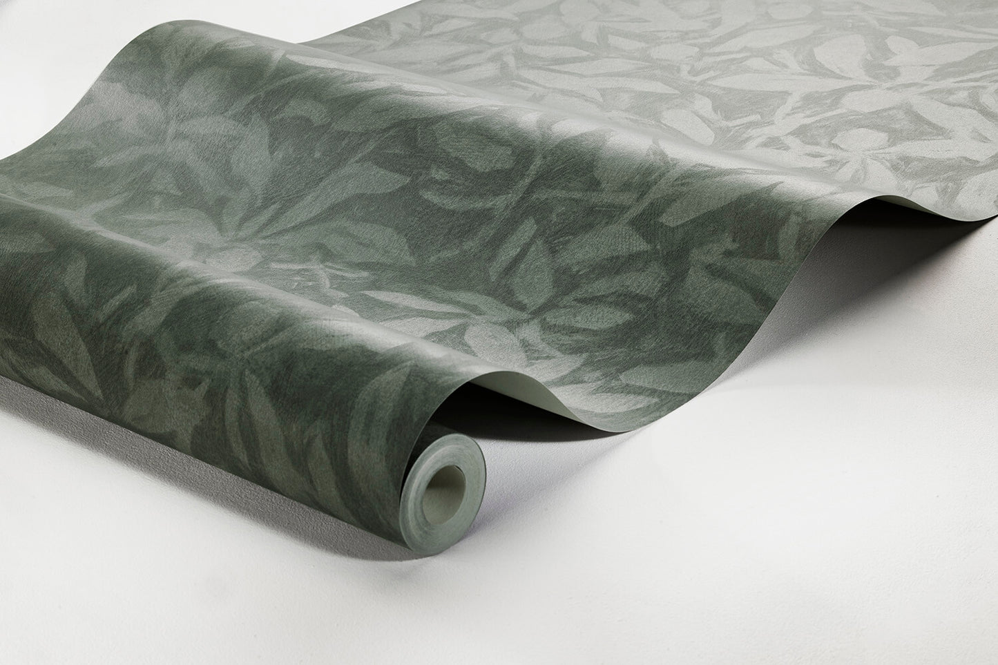 Colored in contrasting green tones with a hint of blue, our Skogsparken wallpaper was inspired by the beautiful play of shadows under an English walnut tree on a sunny Autumn Day.